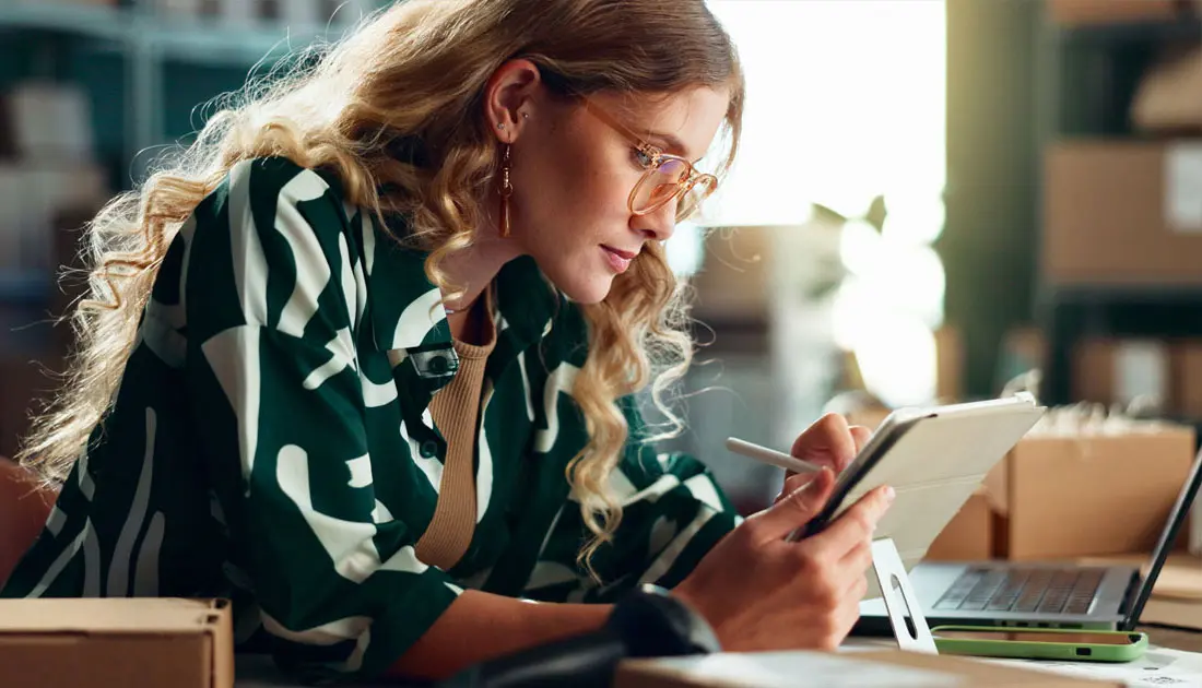 photo-of-a-woman-conducting-online-business-with-storage-boxes-next-to-her-facing-left
