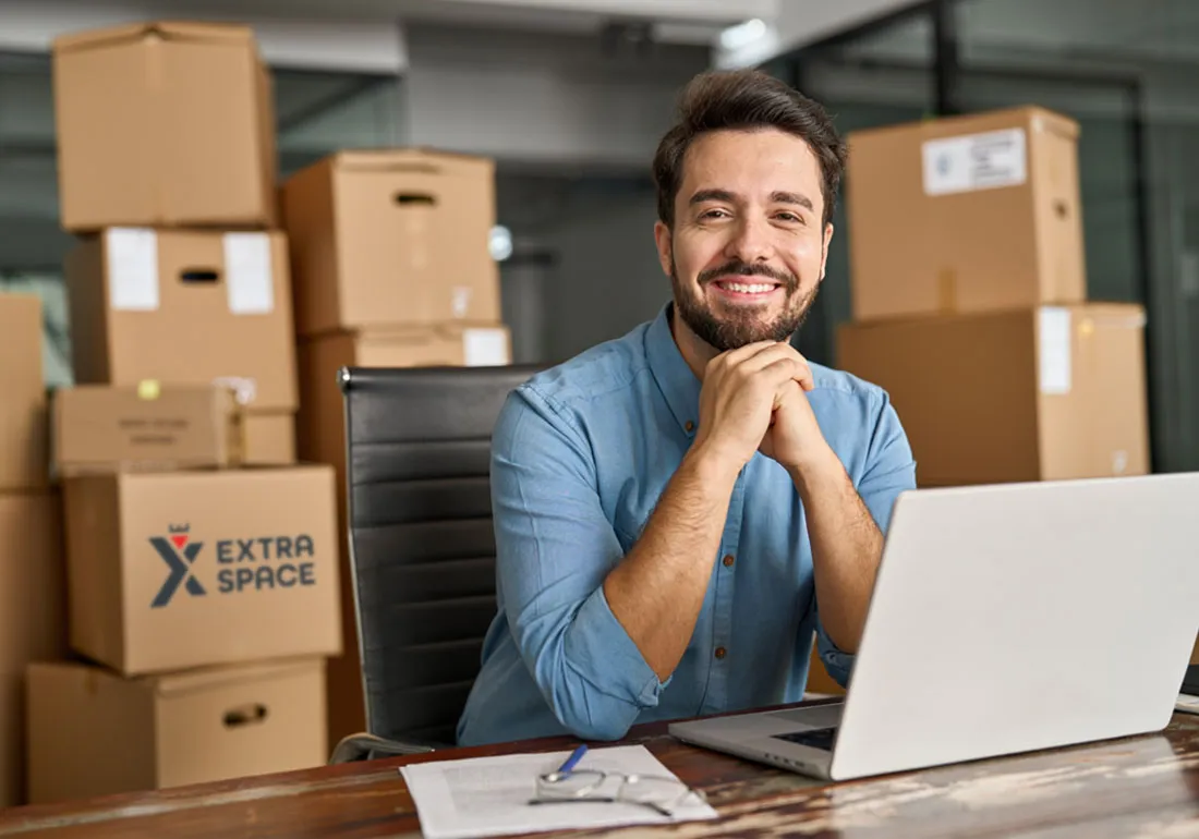 photo-of-man-in-the-office-with-storage-boxes-behind-him