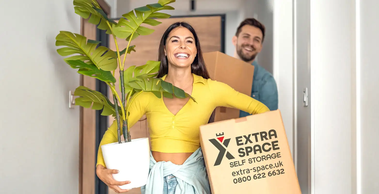 hero-young-couple-moving-in-new-home-couple-is-having-fun-with-cardboard-boxes-in-new-house