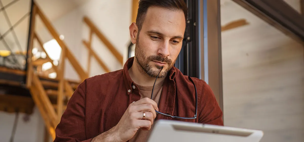 man-at-home-looking-at-tablet-photo